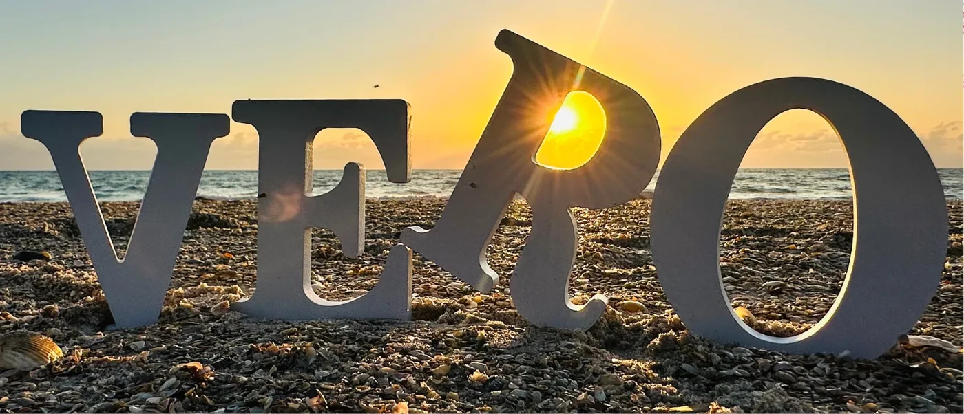 The letters VERO standing on a Vero Beach shell beach at sunrise